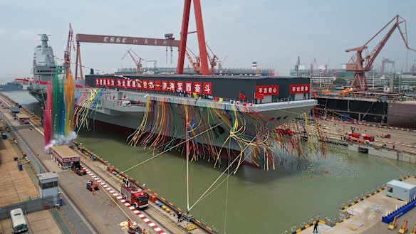 The Fujian, seen here at its launch, can dispatch planes deep into Pacific territory. 