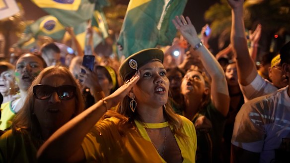 Supporters of Jair Bolsonaro celebrate in front of his residence in Rio.