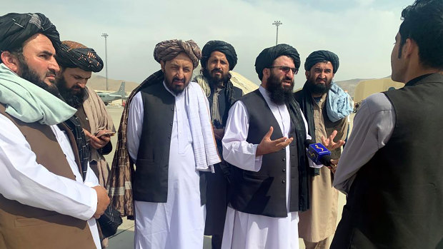 Taliban officials are interviewed by journalists inside the Hamid Karzai International Airport earlier this week.