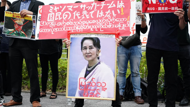 Myanmar citizens protest in Japan holding a picture of ousted leader Aung San Suu Kyi.