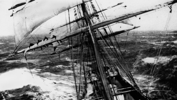 A picture from the previously missing ship Glenbank shows several crew members hanging onto one of the sails as the ship tilts in rough seas. 