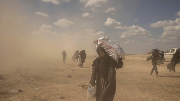 A woman carries supplies from the reception area.