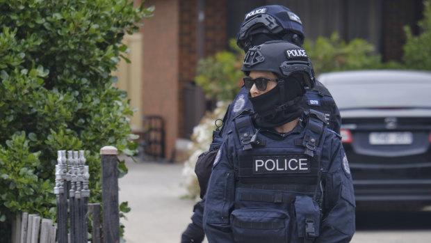 Police guard the house of a suspect terrorist in Dallas on Tuesday