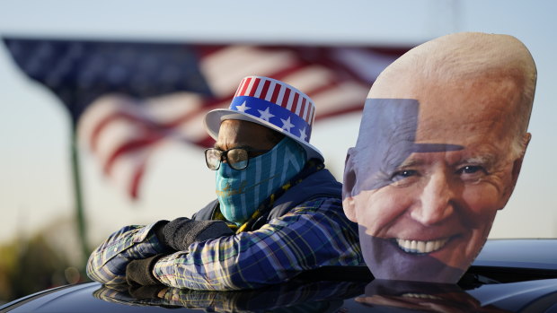 A Democrat supporter watches Joe Biden address a rally in Michigan on Saturday.