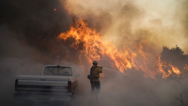 Firefighter Raymond Vasquez battles the Silverado Fire in Irvine, California on on Monday.
