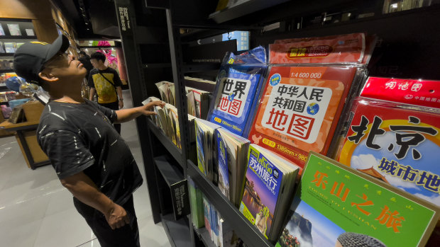 People browse near the new map, on display for sale at a bookshop in Beijing.