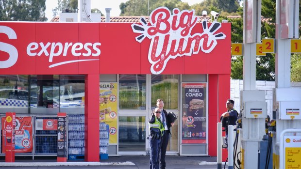 Police are seen at the Coles Express petrol station at the corner of Kings Road and Melton Highway. 