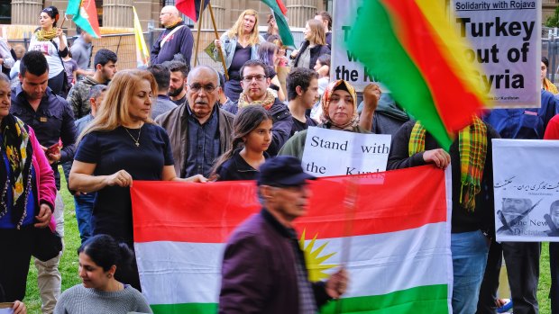 Protesters taking part in a Kurdish rally in front of the State Library in Melbourne on Saturday.