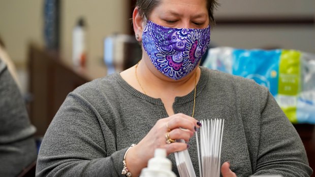 Municipal workers extract Luzerne County, Pennsylvania ballots from their envelopes in Wilkes-Barre.