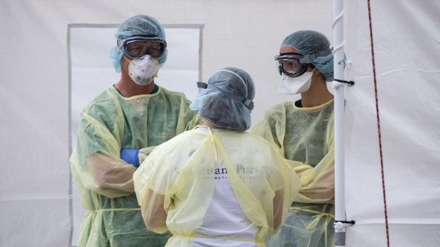 Medical workers near Milan in northern Italy prepare to treat more patients. 