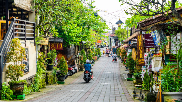 Tourists strolling along the central street of Ubud.