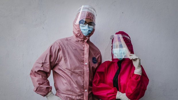 Drs Yohanes Ridora, left, and Nabila Kirtti pose during a virtual fashion show of personal protective equipment (PPE) in Yogyakarta, Indonesia. The fashion show was held as a form of gratitude for medical personnel.