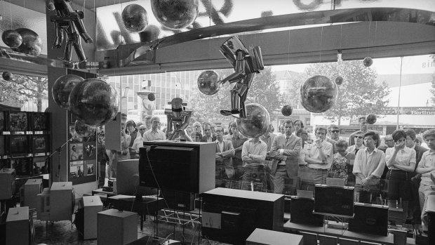 Mesmerised viewers watch the Apollo 11 moon landing.