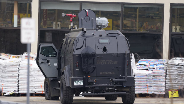 Police work on the scene outside a grocery store where a shooting took place.