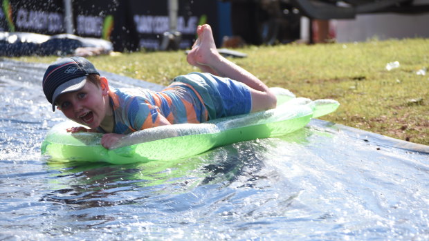 William cools down on a slip and slide at Lake Moondarra in Mount Isa, 120 kilometres west of Cloncurry.