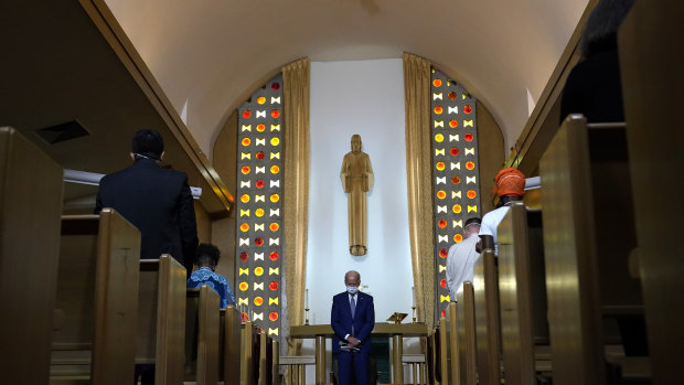 Democratic presidential candidate former vice-president Joe Biden bows his head in prayer at Grace Lutheran Church in Kenosha, Wisconsin.