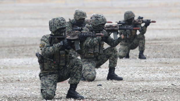 South Korean army soldiers aim their machine guns during a defence expo, in Goyang, South Korea. 