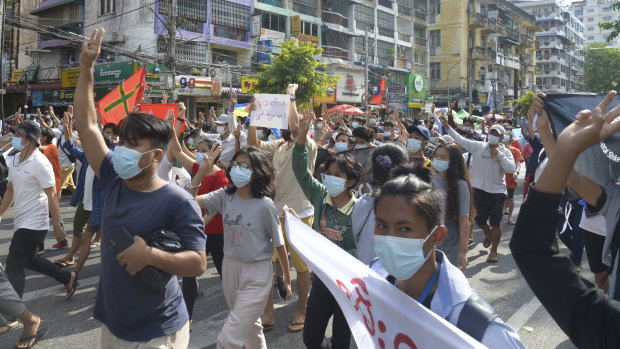 Anti-coup protesters flash the three-finger salute of defiance during a demonstration in Yangon.