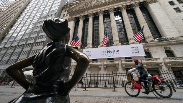 The New York Stock Exchange and Fearless Girl, a bronze sculpture by Kristen Visbal in New York. 