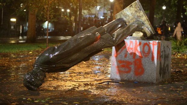 Protesters toppled statues of Theodore Roosevelt and Abraham Lincoln in Portland in October.
