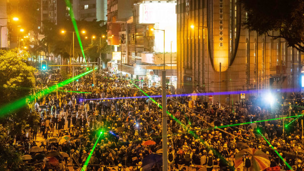 Pro-democracy protesters shine laser pointers during a clash at Admiralty district in Hong Kong.