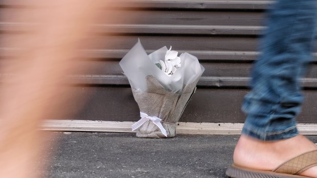 A single flower pot is seen outside the Love Machine nightclub.