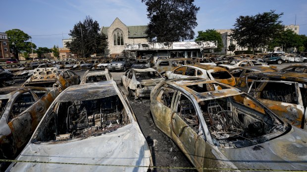 Charred vehicles sit in a car park following a night of unrest in Kenosha, Wisconsin. Anger over the shooting of Jacob Blake, a black man, by police drove a third night of protests on Wednesday.