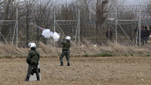 Greek riot police fire tear gas at migrants who try to enter Greece from Turkey at the Greek-Turkish border in Kastanies on Wednesday.