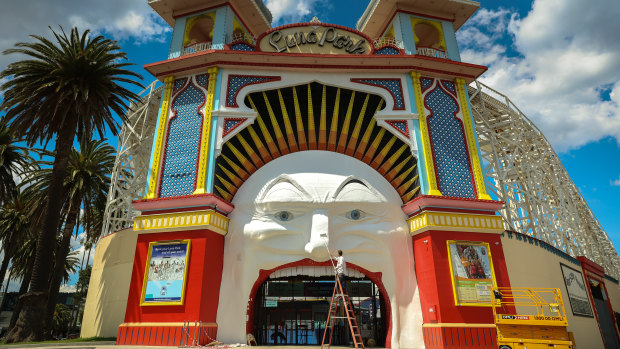 Artist Mark Ogge paints key features of Mr Moon’s face at Luna Park before 110th birthday celebrations in December. 