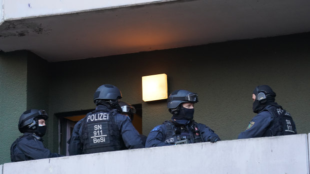 Police raid an apartment building in Berlin in connection with last year's jewel heist in Dresden. 