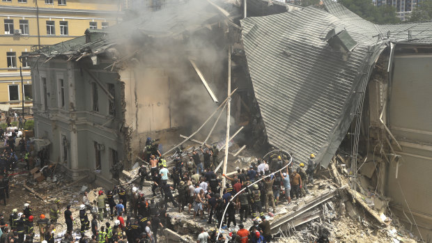 Rescuers and volunteers clean up the rubble and search for victims after a Russian missile hit the country’s main children’s hospital Okhmadyt in Kyiv.