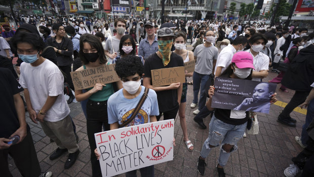 People gather to protest during a solidarity rally for the death of George Floyd in Tokyo.