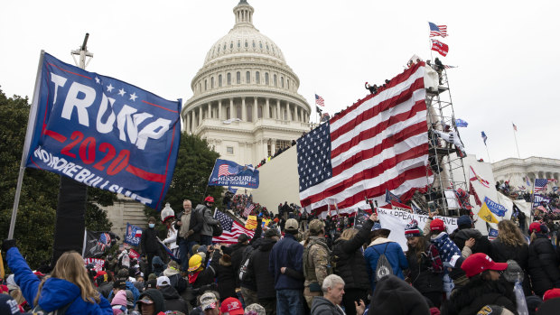 Rioters stand outside the US Capitol in Washington on January 6, 2021.