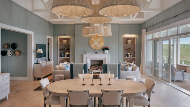 The villa’s elegant dining space opens to a deck.