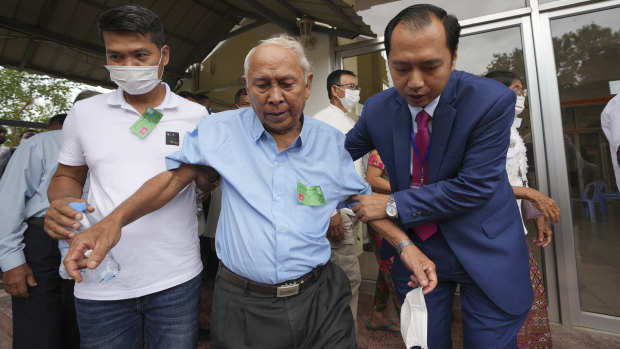 Chum Mey, a survivor of imprisonment during the Khmer Rouge rule, leaves the court after watching the verdict.