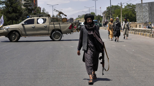 Taliban fighters guard at the site of an explosion in Kabul, Afghanistan in June.