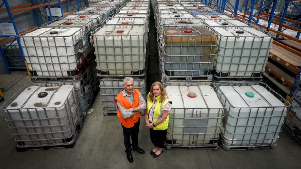 David Barry Logistics operations director Stephen Campbell and CEO Sonya Constantine in front of toxic waste sent to their storage facility by Bradbury Industrial Services.