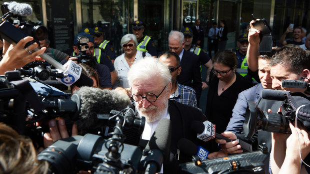 George Pell's barrister Robert Richter, QC, is surrounded by the media as he leaves court on Wednesday.
