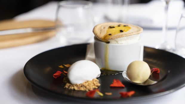 The passionfruit soufflé arrives lofty and proud, with a coconut sorbet and a white chocolate.
