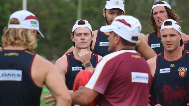Neale and his teammates receive instruction at training.