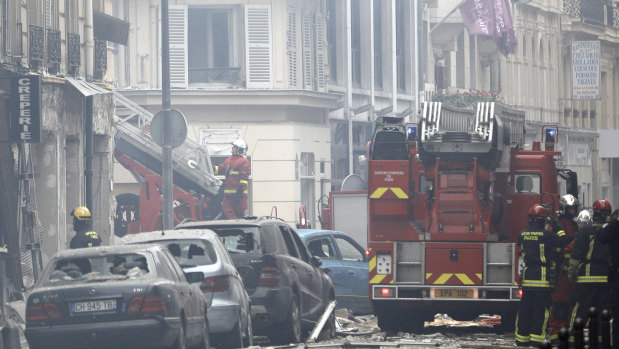 Firefighters work at the scene of a gas leak explosion in Paris