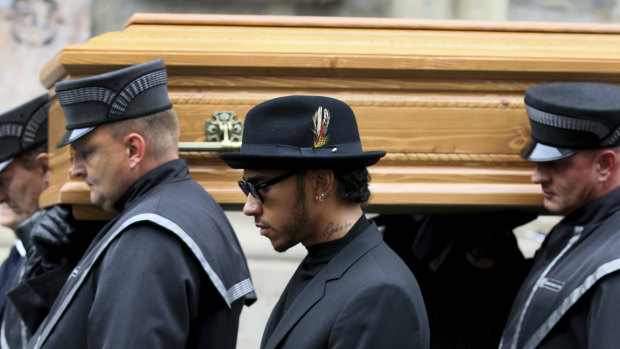 Lewis Hamilton (centre) attend the funeral.