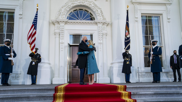 President Joe Biden and first lady Jill Biden embrace in front of the White House in Washington
