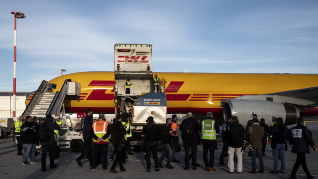 A shipment of Pfizer-BioNTech Covid-19 vaccines is unloaded from a DHL Worldwide Express cargo plane at Athens International airport, in Athens, Greece.