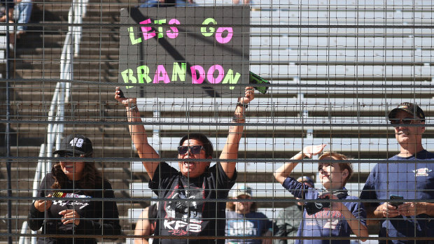 A NASCAR fan holds a “Lets Go Brandon” sign at a race in Fort Worth, Texas.