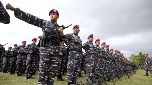 Soldiers stand to attention at a security parade in Bali before the G20.