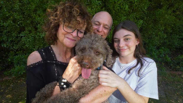 Tracey Smith with Graeme Smith and daughter Catherine holding their dog Lenny.