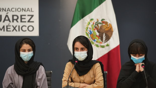 Several of the original members of the Afghan all-girls robotics team, who have received threats from the Taliban, attend a press conference after arriving at the Benito Juarez International Airport in Mexico City.