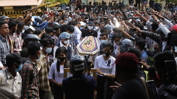 The casket containing the body of Mya Thwet Thwet Khine being bringing through the crowds towards the cemetery in Naypyitaw Myanmar.