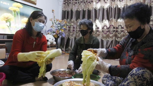 A family in Somun-dong prepares Kimchi for the coming winter with their neighbours at their home in Pyongyang, North Korea.